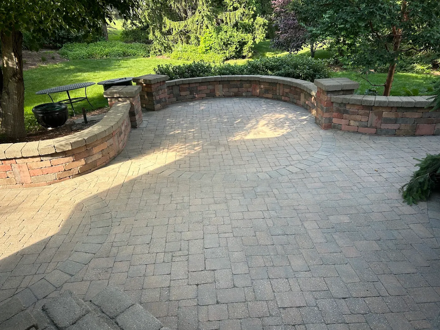 Curved paver patio with seat walls, cleaned